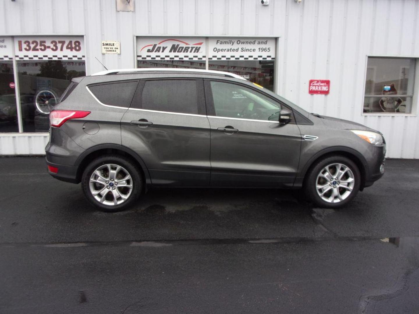 2015 GRAY FORD ESCAPE TITANIUM (1FMCU9J92FU) with an 2.0L engine, Automatic transmission, located at 501 E. Columbia St., Springfield, OH, 45503, (800) 262-7122, 39.925262, -83.801796 - ***Clean Carfax***4WD***Heated Leather Seating***Moonroof***Navigation***Titanium***Serviced and Detailed*** Jay North Auto has offered hand picked vehicles since 1965! Our customer's enjoy a NO pressure buying experience with a small town feel. All of our vehicles get fully inspected and detail - Photo#0