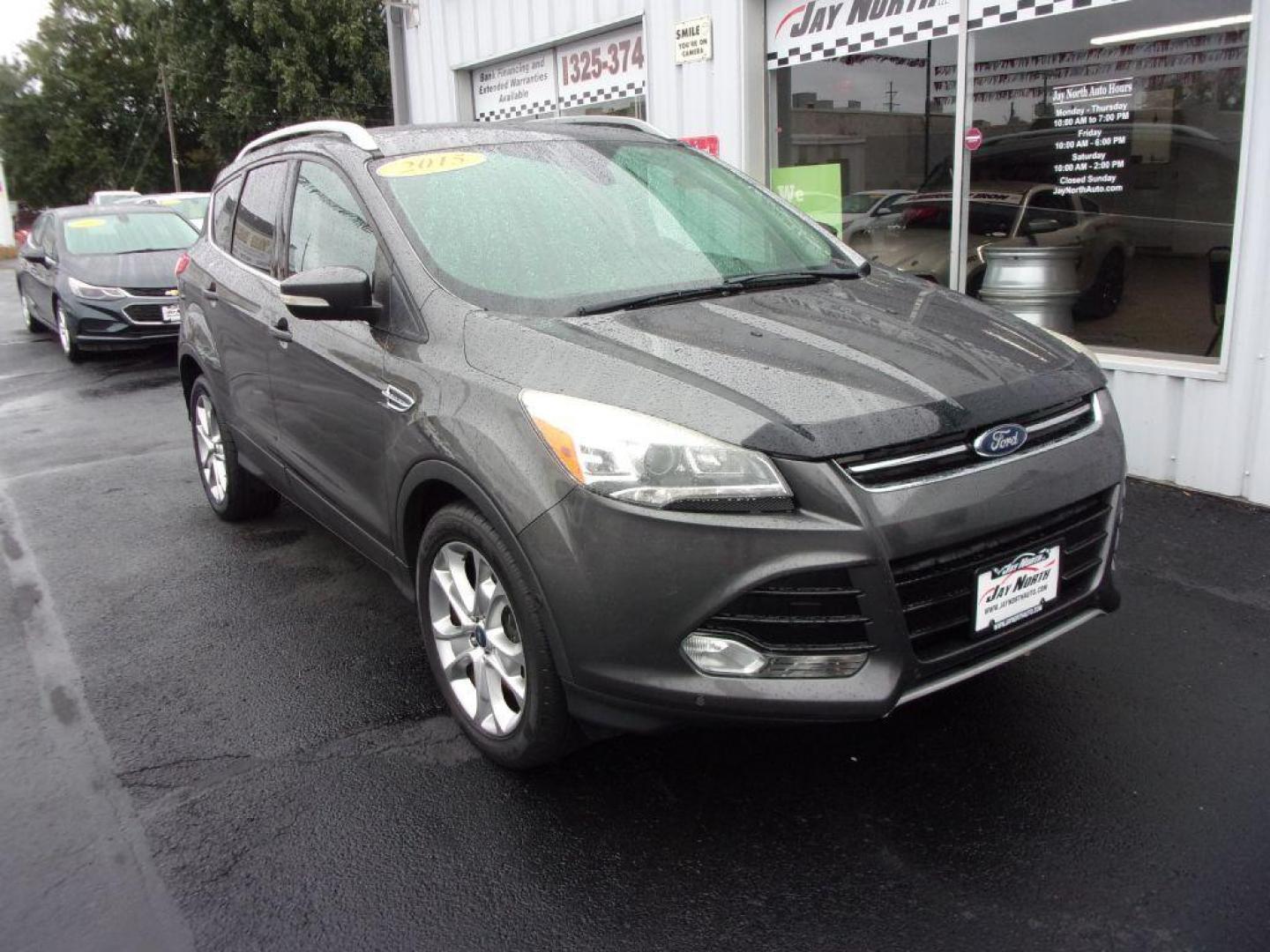 2015 GRAY FORD ESCAPE TITANIUM (1FMCU9J92FU) with an 2.0L engine, Automatic transmission, located at 501 E. Columbia St., Springfield, OH, 45503, (800) 262-7122, 39.925262, -83.801796 - ***Clean Carfax***4WD***Heated Leather Seating***Moonroof***Navigation***Titanium***Serviced and Detailed*** Jay North Auto has offered hand picked vehicles since 1965! Our customer's enjoy a NO pressure buying experience with a small town feel. All of our vehicles get fully inspected and detail - Photo#2