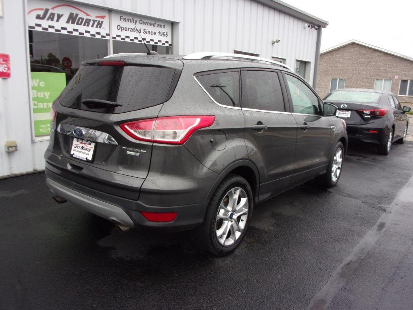 2015 GRAY FORD ESCAPE TITANIUM (1FMCU9J92FU) with an 2.0L engine, Automatic transmission, located at 501 E. Columbia St., Springfield, OH, 45503, (800) 262-7122, 39.925262, -83.801796 - ***Clean Carfax***4WD***Heated Leather Seating***Moonroof***Navigation***Titanium***Serviced and Detailed*** Jay North Auto has offered hand picked vehicles since 1965! Our customer's enjoy a NO pressure buying experience with a small town feel. All of our vehicles get fully inspected and detail - Photo#3