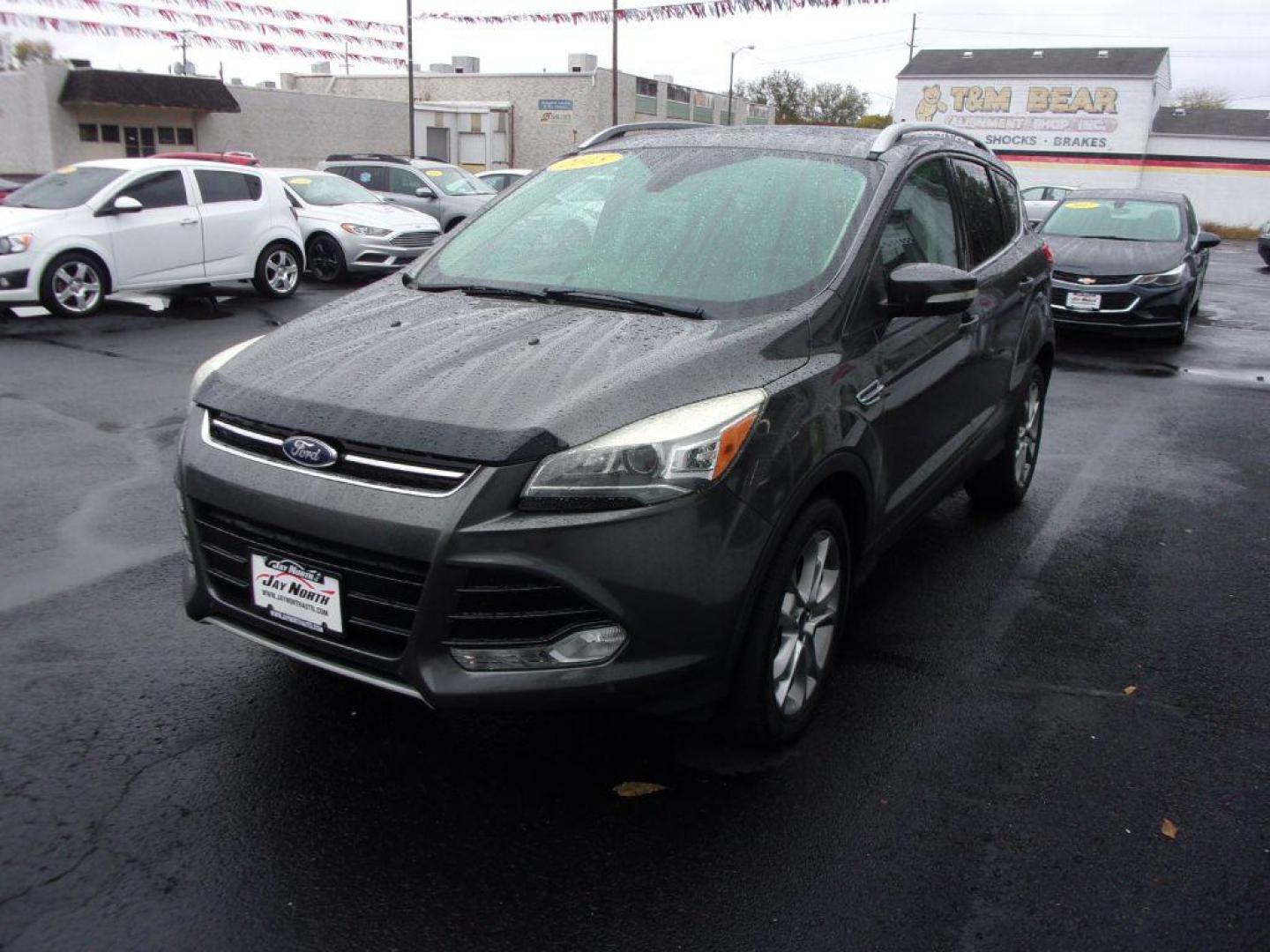 2015 GRAY FORD ESCAPE TITANIUM (1FMCU9J92FU) with an 2.0L engine, Automatic transmission, located at 501 E. Columbia St., Springfield, OH, 45503, (800) 262-7122, 39.925262, -83.801796 - ***Clean Carfax***4WD***Heated Leather Seating***Moonroof***Navigation***Titanium***Serviced and Detailed*** Jay North Auto has offered hand picked vehicles since 1965! Our customer's enjoy a NO pressure buying experience with a small town feel. All of our vehicles get fully inspected and detail - Photo#6