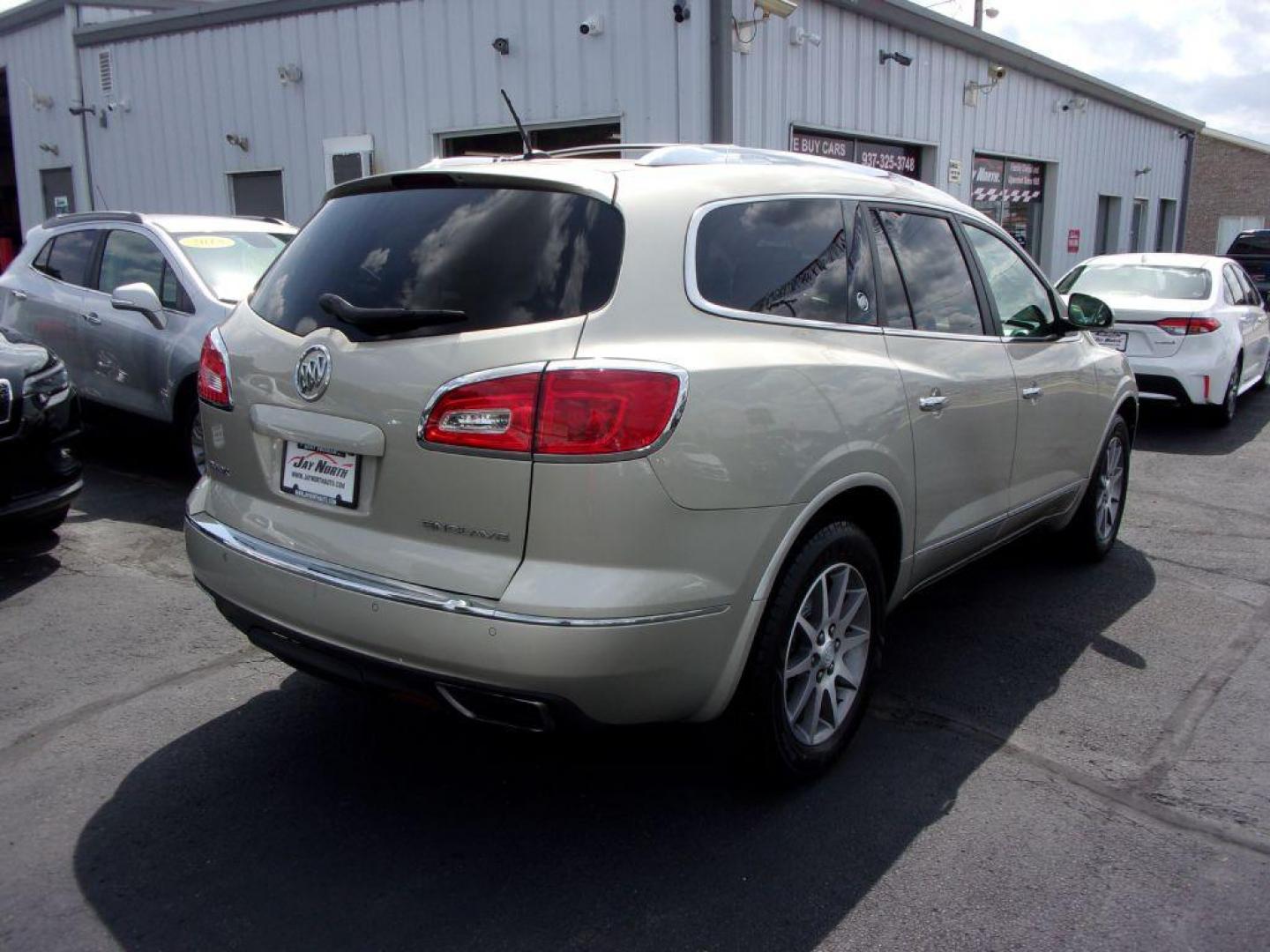 2013 GOLD BUICK ENCLAVE LEATHER GROUP (5GAKRCKD4DJ) with an 3.6L engine, Automatic transmission, located at 501 E. Columbia St., Springfield, OH, 45503, (800) 262-7122, 39.925262, -83.801796 - ***Leather Group***Dual Moonroof***3rd Row Seating***Heated Leather Seating***Rear Captian Chairs***Power Lift Gate***Serviced and Detailed*** - Photo#3