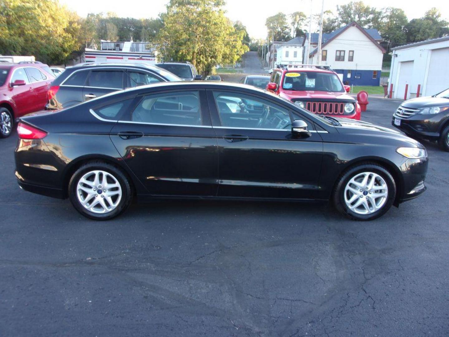 2015 BLACK FORD FUSION SE (1FA6P0H74F5) with an 2.5L engine, Automatic transmission, located at 501 E. Columbia St., Springfield, OH, 45503, (800) 262-7122, 39.925262, -83.801796 - Photo#0