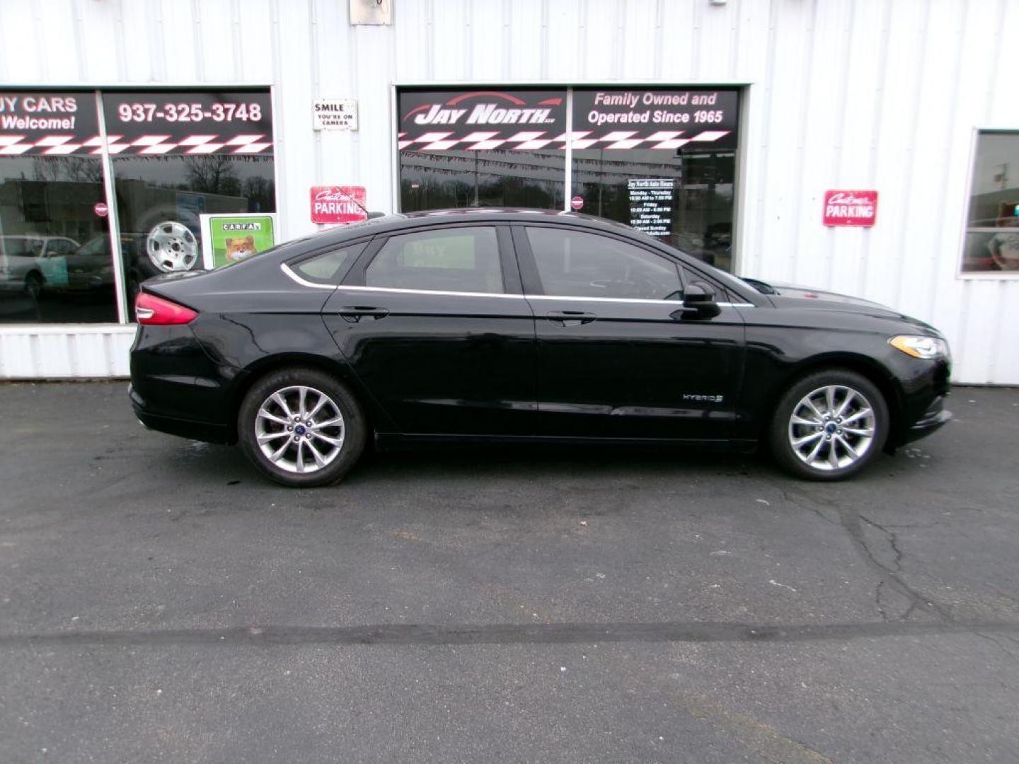 2017 BLACK FORD FUSION SE HYBRID (3FA6P0LU1HR) with an 2.0L engine, Continuously Variable transmission, located at 501 E. Columbia St., Springfield, OH, 45503, (800) 262-7122, 39.925262, -83.801796 - Photo#0