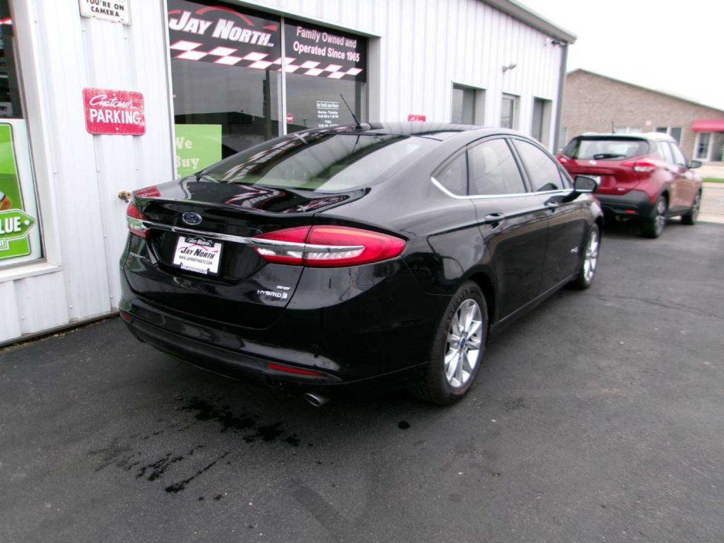 2017 BLACK FORD FUSION SE HYBRID (3FA6P0LU1HR) with an 2.0L engine, Continuously Variable transmission, located at 501 E. Columbia St., Springfield, OH, 45503, (800) 262-7122, 39.925262, -83.801796 - Photo#3