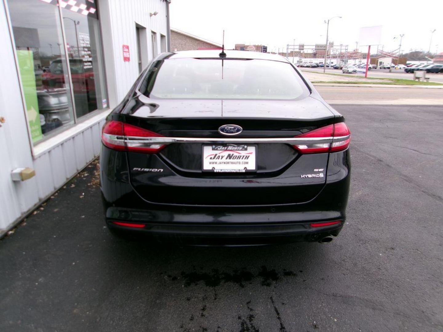 2017 BLACK FORD FUSION SE HYBRID (3FA6P0LU1HR) with an 2.0L engine, Continuously Variable transmission, located at 501 E. Columbia St., Springfield, OH, 45503, (800) 262-7122, 39.925262, -83.801796 - Photo#4