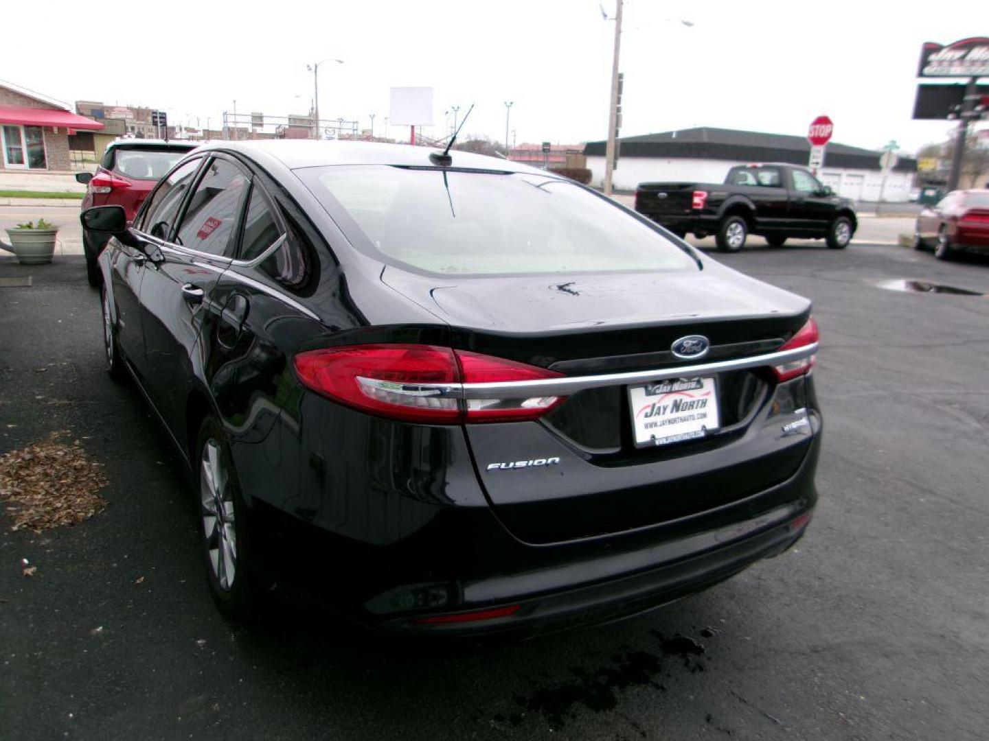 2017 BLACK FORD FUSION SE HYBRID (3FA6P0LU1HR) with an 2.0L engine, Continuously Variable transmission, located at 501 E. Columbia St., Springfield, OH, 45503, (800) 262-7122, 39.925262, -83.801796 - Photo#5