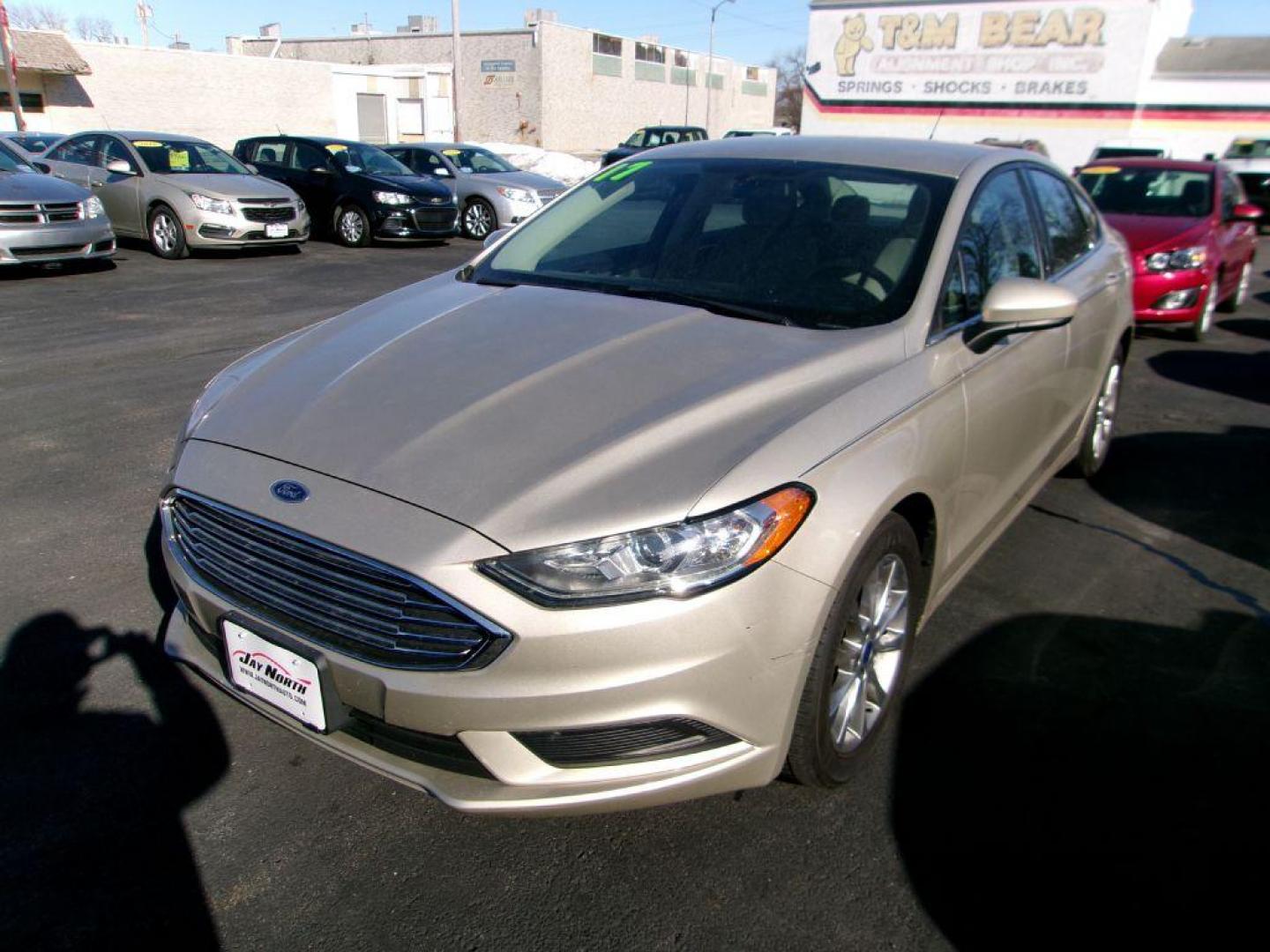 2017 GOLD FORD FUSION SE (3FA6P0H72HR) with an 2.5L engine, Automatic transmission, located at 501 E. Columbia St., Springfield, OH, 45503, (800) 262-7122, 39.925262, -83.801796 - *** Serviced and Detailed *** FWD *** SE *** Back Up Camera *** Jay North Auto has offered hand picked vehicles since 1965! Our customer's enjoy a NO pressure buying experience with a small town feel. All of our vehicles get fully inspected and detailed. We are a preferred dealer for many local - Photo#3