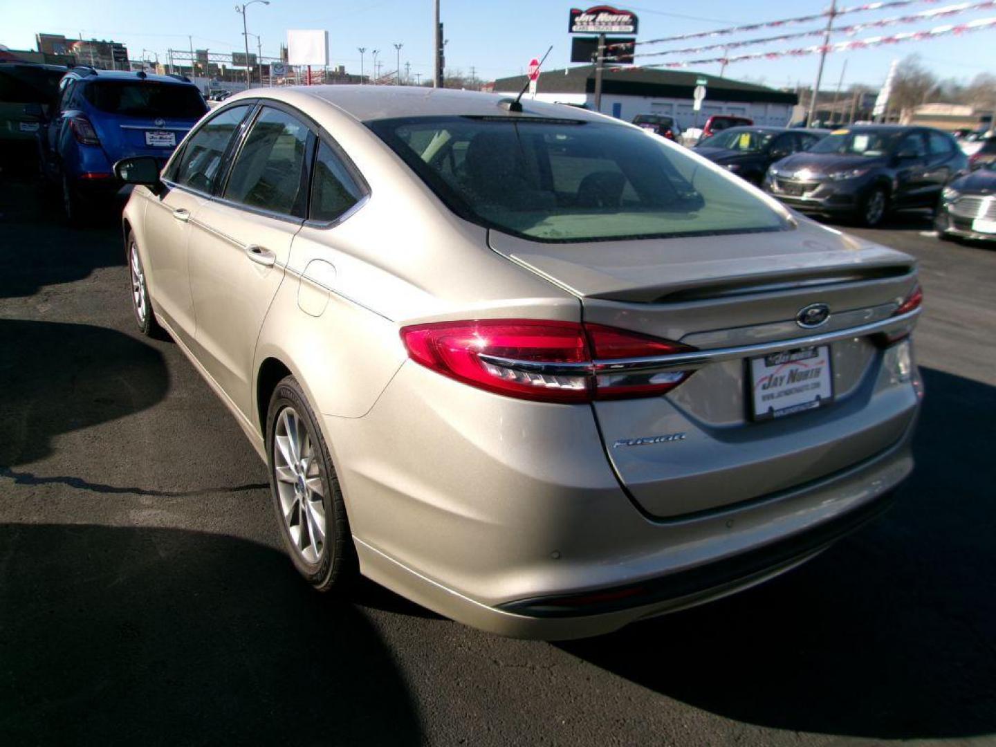 2017 GOLD FORD FUSION SE (3FA6P0H72HR) with an 2.5L engine, Automatic transmission, located at 501 E. Columbia St., Springfield, OH, 45503, (800) 262-7122, 39.925262, -83.801796 - *** Serviced and Detailed *** FWD *** SE *** Back Up Camera *** Jay North Auto has offered hand picked vehicles since 1965! Our customer's enjoy a NO pressure buying experience with a small town feel. All of our vehicles get fully inspected and detailed. We are a preferred dealer for many local - Photo#4