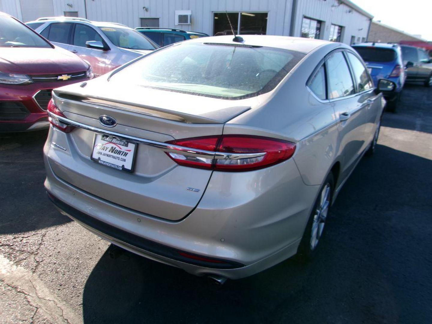 2017 GOLD FORD FUSION SE (3FA6P0H72HR) with an 2.5L engine, Automatic transmission, located at 501 E. Columbia St., Springfield, OH, 45503, (800) 262-7122, 39.925262, -83.801796 - *** Serviced and Detailed *** FWD *** SE *** Back Up Camera *** Jay North Auto has offered hand picked vehicles since 1965! Our customer's enjoy a NO pressure buying experience with a small town feel. All of our vehicles get fully inspected and detailed. We are a preferred dealer for many local - Photo#6